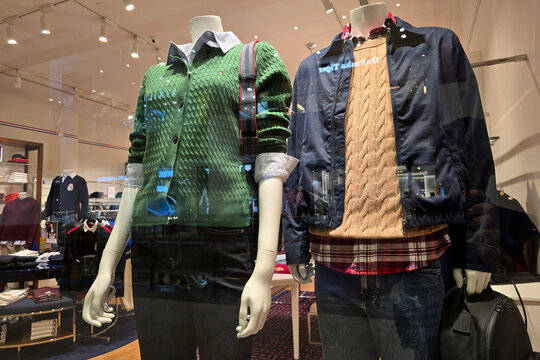 Penang, Malaysia &ndash; November 6, 2025: Close-up of Tommy Hilfiger window display featuring male and female mannequins dressed in layered sweaters, jackets and casual wear at Gurney Plaza shopping mall.
