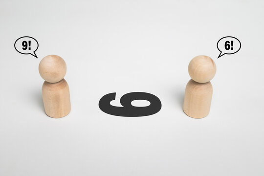 two wooden figurine arguing number 6 or 9 on white background. concept of different point of view or perspective view