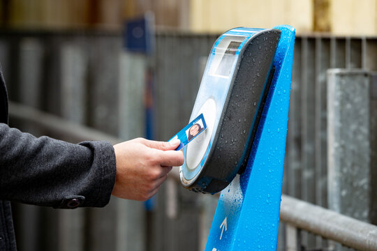 Close-up of hands tapping off at a train station in Auckland