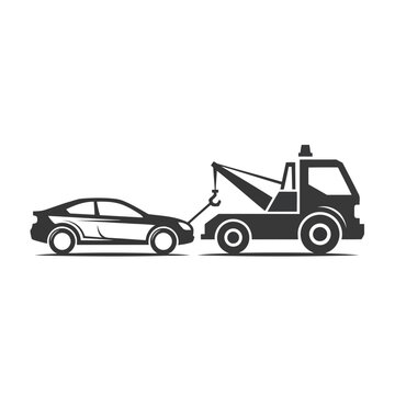 Car being towed away by a tow truck on a roadside with a clear view