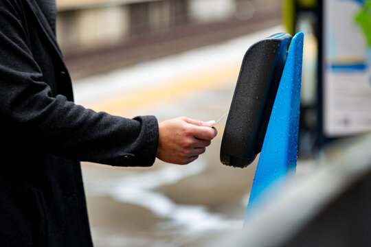 Close-up of hands tapping off at a train station in Auckland
