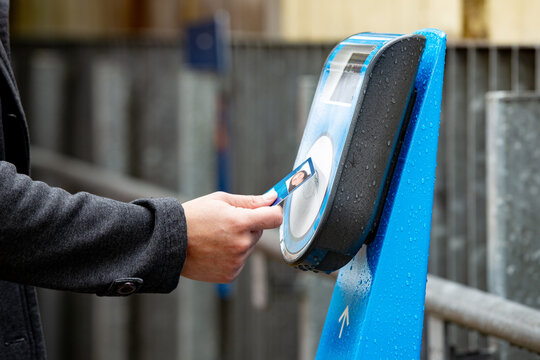 Close-up of hands tapping off at a train station in Auckland