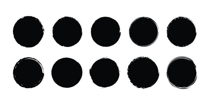 A set of ten distressed black grunge circles with rough brush stroke textures on a white background
