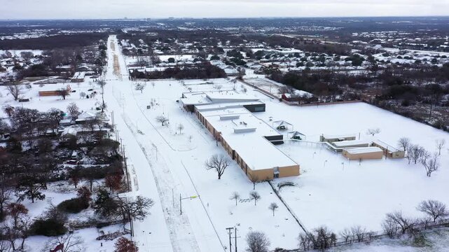 Aerial drone orbit of Fort Worth Snow covered park & suburbs after January 2026 snow and sleet fall