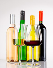 Obraz premium Different wine bottles and glasses on white background