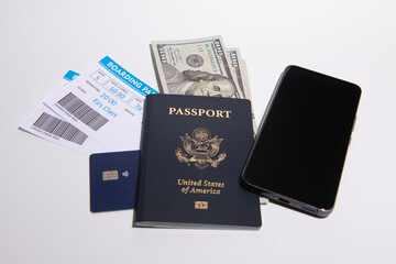 US passport with boarding passes cash credit card and smartphone on white background. International...