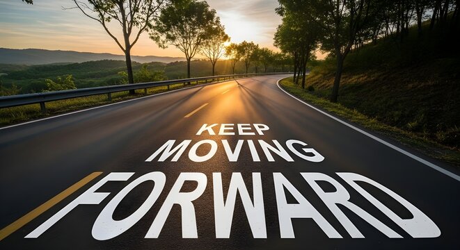 Inspiring motivational message painted on dark asphalt roadway winding through scenic sunlit countryside at sunrise