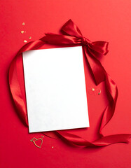 White card centered, surrounded by red ribbon and gold hearts on a red background
