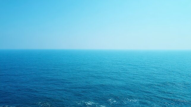 Tranquil Blue Ocean Horizon Under Clear Skies Reflecting Soft Sunlight in a Serene Landscape