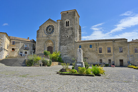 Altomonte church Saint Mary of Consolation standing on cobbled square. Altomonte cathedral Saint Mary of Consolation features gothic architecture and a prominent rose window.