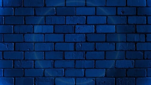 A neon blue circle illuminates against a dark, textured brick wall background