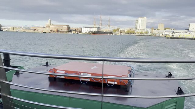 Ferry crossing Portsmouth Harbour toward Gosport with historic ship in view