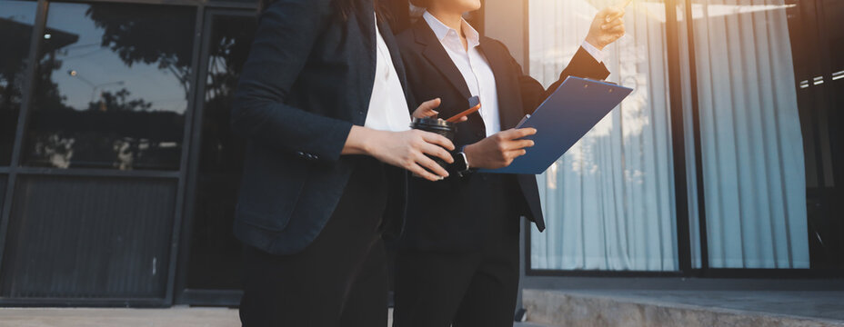 Business people walking and talk to each other in front of modern office
