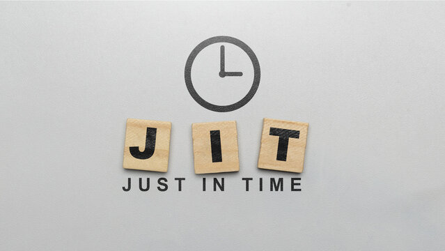 Business concept for Just-In-Time (JIT) manufacturing and logistics. Wooden letter tiles spelling JIT with a clock icon and the full phrase on a grey textured background