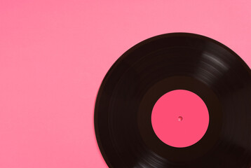 Black vinyl record with pink label on pink background
