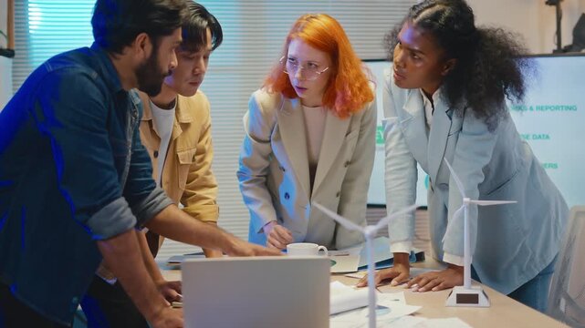 group of multiethnic businesspeople in team meeting,using tablet computer for Net zero,ESG topic presentation on monitor. Sustainable business practice,global warming,earth day,ESG team concept