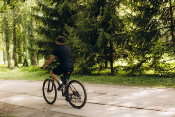 Man cycling on park trail in nature