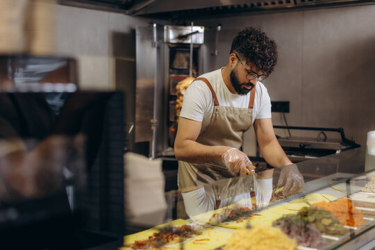 Chef preparing doner kebab meat for a wrap