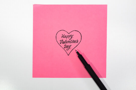 Handwritten Romantic Note on Pink Paper with Pen
