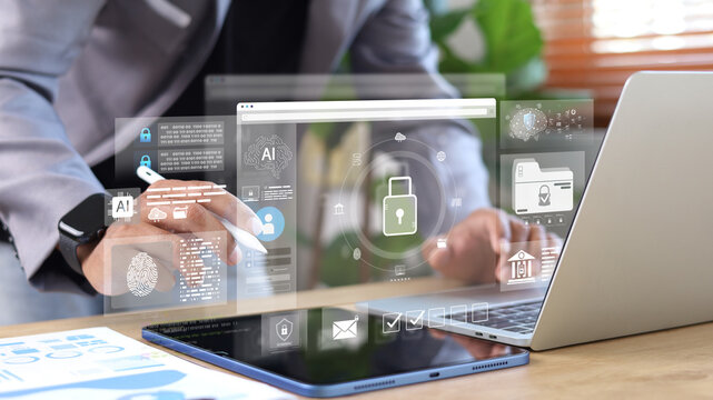 Business professional using tablet and laptop with AI security interface, biometric authentication and data protection. Concept of cybersecurity, identity access management and secure digital systems.
