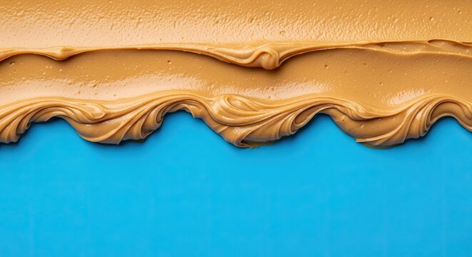 Creamy Peanut Butter Texture with Wavy Edge on Vibrant Blue Background