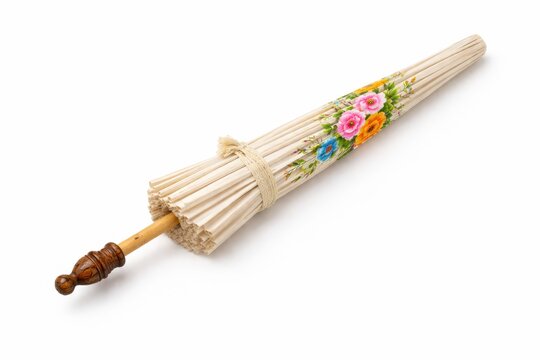 Closed Northern Thai Lanna paper umbrella folded and tied with woven strap carved teak handle bamboo shaft studio product photo isolated on white background