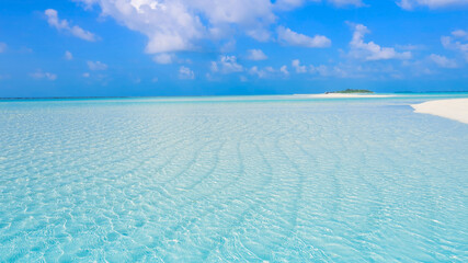 Fototapeta premium Summer lagoon Ripples in the sand at low tide on a beach with sandbar and blue sea in Maldives island