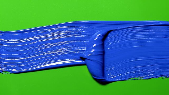 Vibrant Blue Acrylic Paint Stroke on Bright Green Background