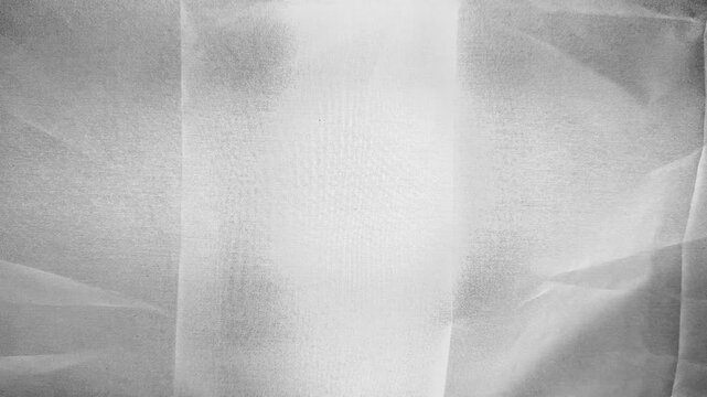 ethereal white tulle fabric softly draping in abstract grayscale texture with subtle folds light gradients and translucent layers