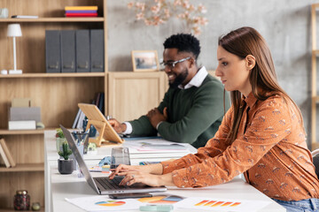 Diverse coworkers collaborating in modern office workspace