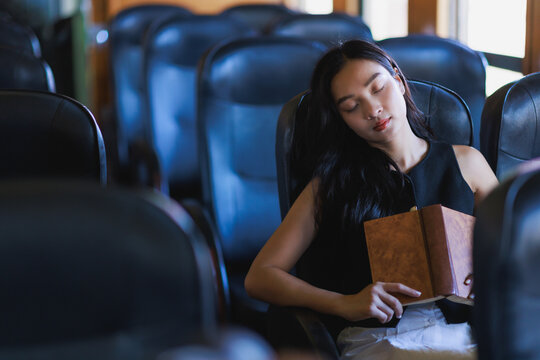 Young woman sleeping during daytime travel on a vehicle