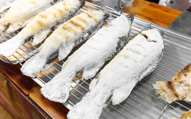 A rack of fish with a white coating on it