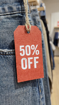 Discount tag featuring 50% off sale on denim clothing