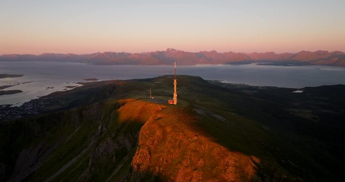 Telecommunication tower atop Storheia mountain near Stokmarknes. Sunset aerial