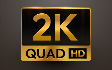 A sleek golden metallic 2K QUAD HD sign on a dark background, symbolizing high definition video standards.