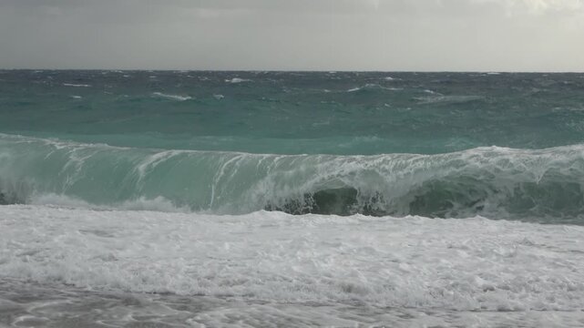 A strong, stormy wind breaks huge waves of the Mediterranean Sea on the beaches of the coast of Antalya, Turkey.