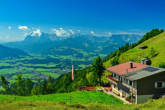 Alpine hut Taubensteinhuette overlooking valley and Kaiser range in Austria