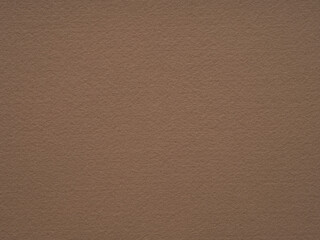 Fototapeta premium Natural dark beige or soft brown felt, velvet texture. Soft background for text, lettering, patchwork or other art work. Full frame backdrop pattern wallpaper of art and stationery material.