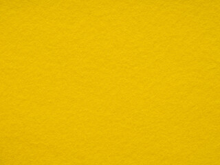 Obraz premium Texture of bright, warm yellow felt material close-up. Full frame retro, vintage pattern. Saturated background for Christmas desktop, holiday New Year, xmas seasonal decoration, lettering, patchwork.