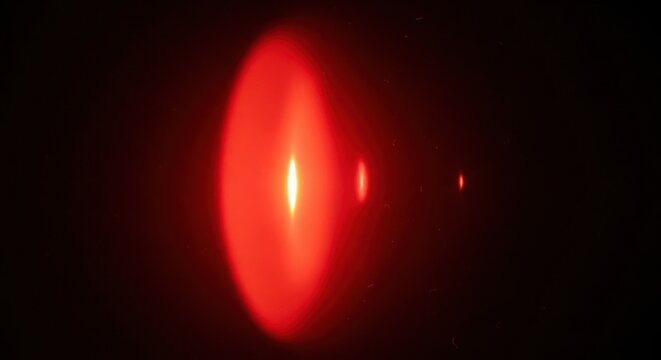 Vertical red light refraction with multiple lens flare reflections