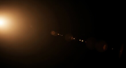 Warm golden lens flare with sunlight bokeh and floating dust