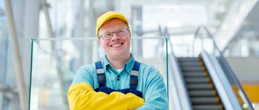Worker with Down syndrome performing service job with pride, dignity at work concept