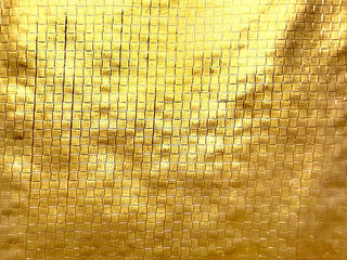 shimmering golden metallic weave texture closeup with intricate grid pattern evoking opulent luxury...