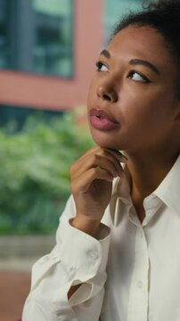 Concentrated African American business woman thinking with laptop at table city cafe businesswoman pensive think creating work job idea female girl worker with computer working deep in thoughts decide