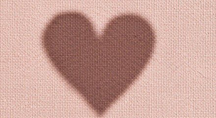 A delicate heart shape woven into a textured, rust-colored fabric background