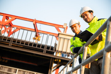 Fototapeta premium Two engineers are examining the operation of various systems in a wastewater treatment plant.