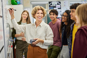 Smiling high school teacher teaching to class