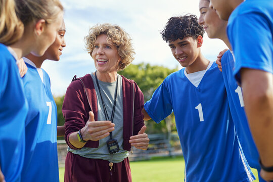 Sport coach giving motivation to young players