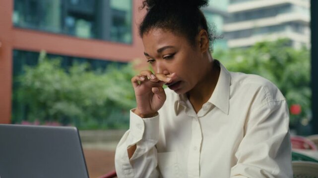 Sick African American business woman working laptop sneezing businesswoman work computer sneeze suffering allergy female girl entrepreneur feeling bad unhealthy allergic problem at table in city cafe