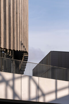 Modern architecture facade building in urban concrete with deep shadow lines and minimal texture showing geometric exterior design perspective